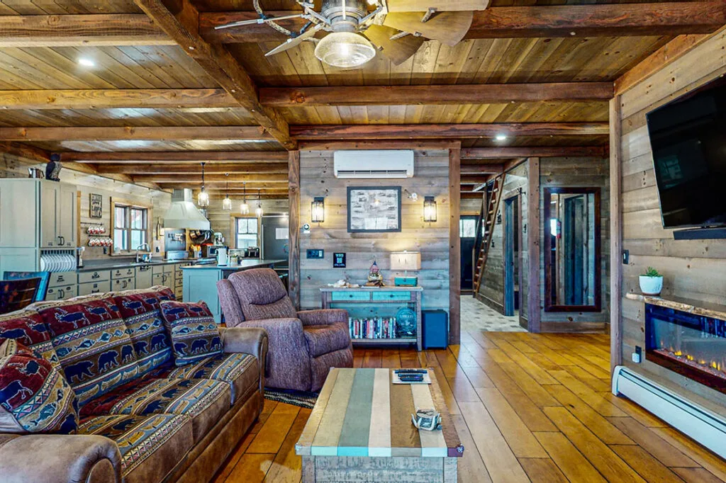 The living room at King's Landing with rustic beams and lake views
