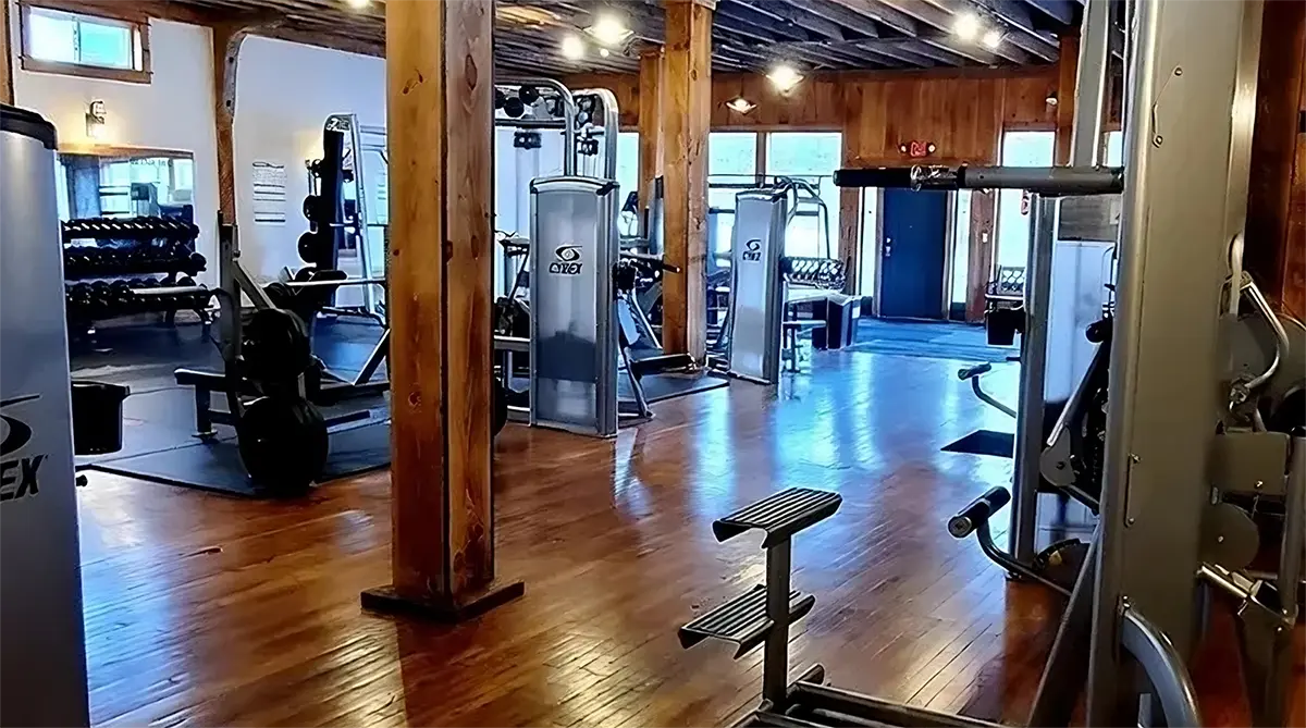 Well-equipped gym interior at Northwoods Fitness, featuring cardio machines, free weights, and resistance equipment, designed for all fitness levels.